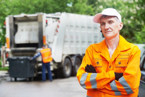 Skip truck delivering waste to a residential property in Hillingdon